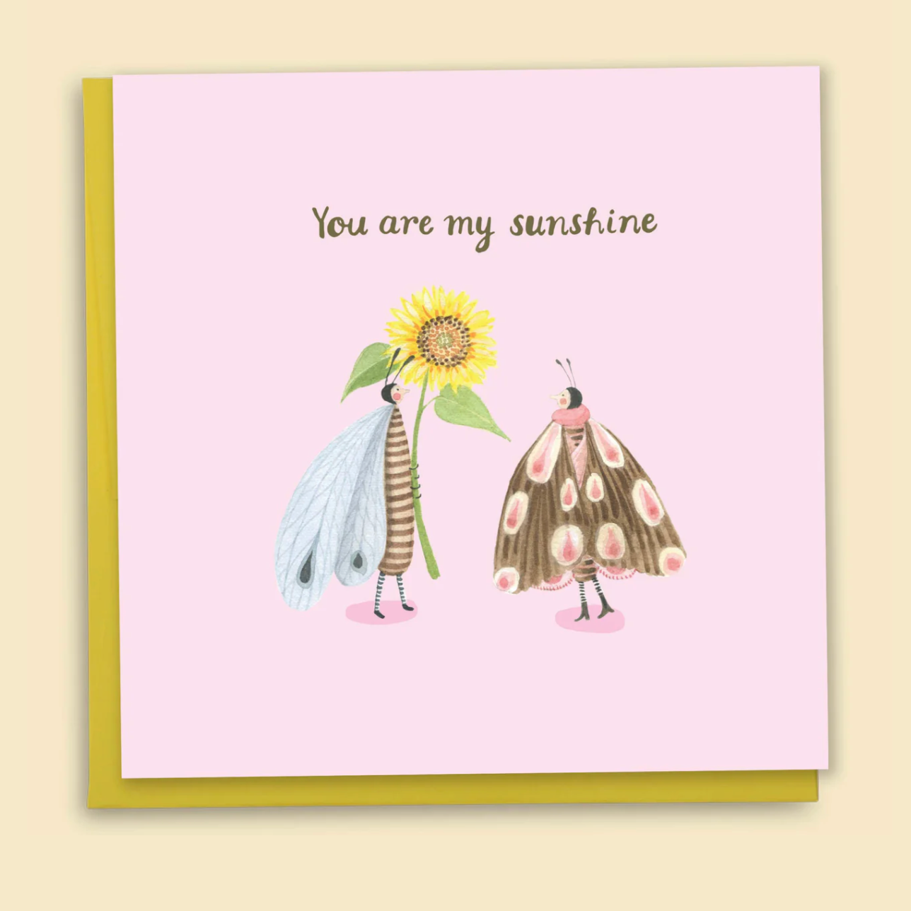 Greeting card with two illustrated characters holding a sunflower and text 'You are my sunshine' on a pink background.